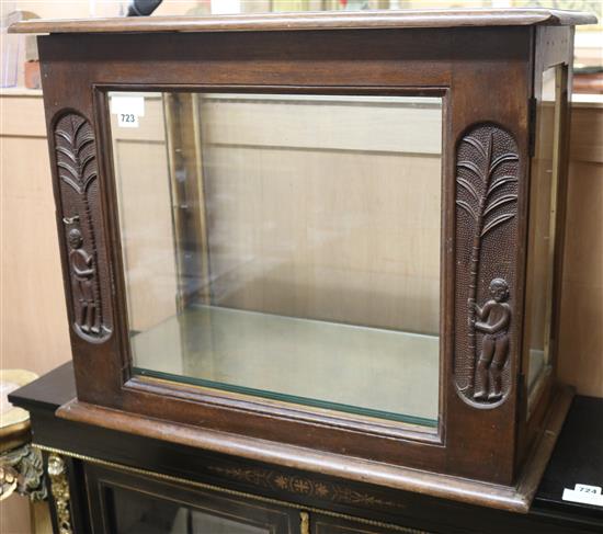 A African hardwood display cabinet, carved with figures beside palm trees, W.2ft 2in.